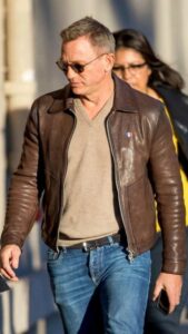 Daniel Craig in brown leather jacket.