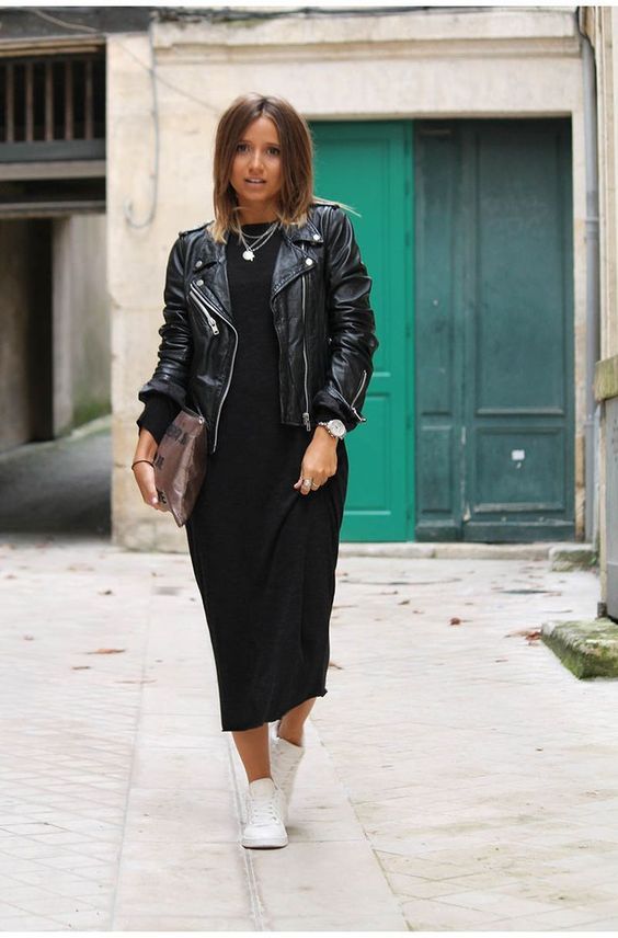 Women wearing a stylish midi dress paired with a black leather jacket, showcasing a chic and edgy contrast between feminine and masculine styles.