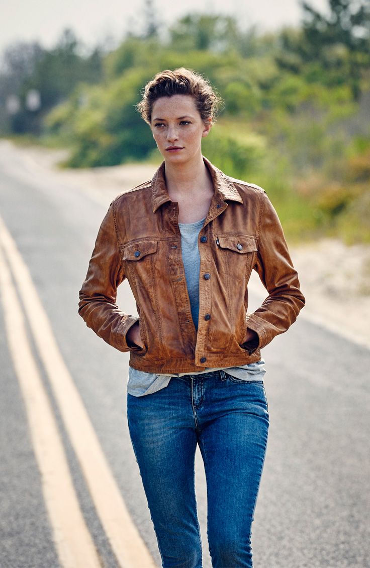 Woman wearing a real leather jacket, looking confident and stylish