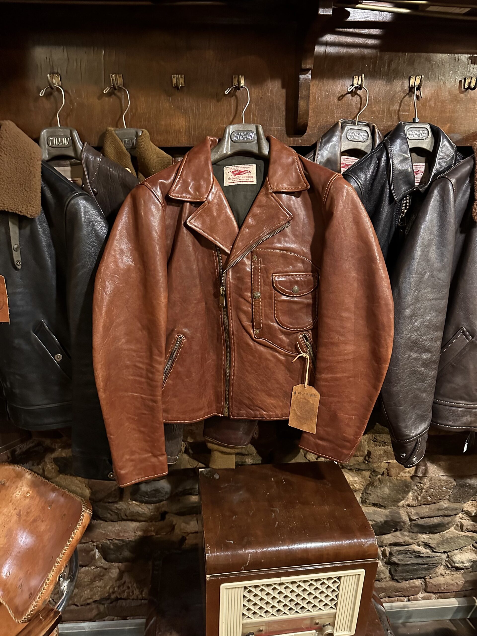 Clean leather jackets hanging on a rack, demonstrating the end result of learning how to clean a leather jacket lining.